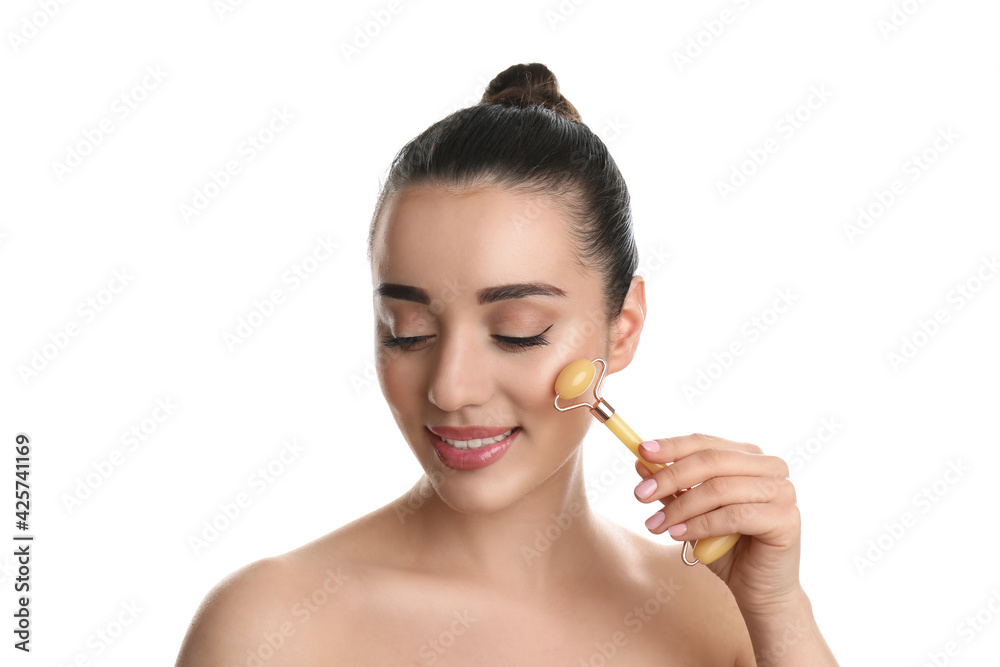 Woman using natural jade face roller on white background Woman using natural jade face roller on white background