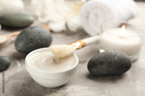 Cosmetic product for spa body wraps on light grey stone background