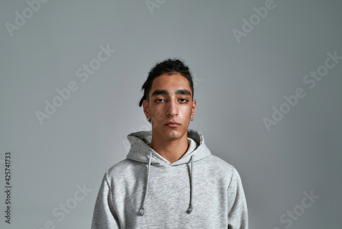 Handsome young gypsy man on light background