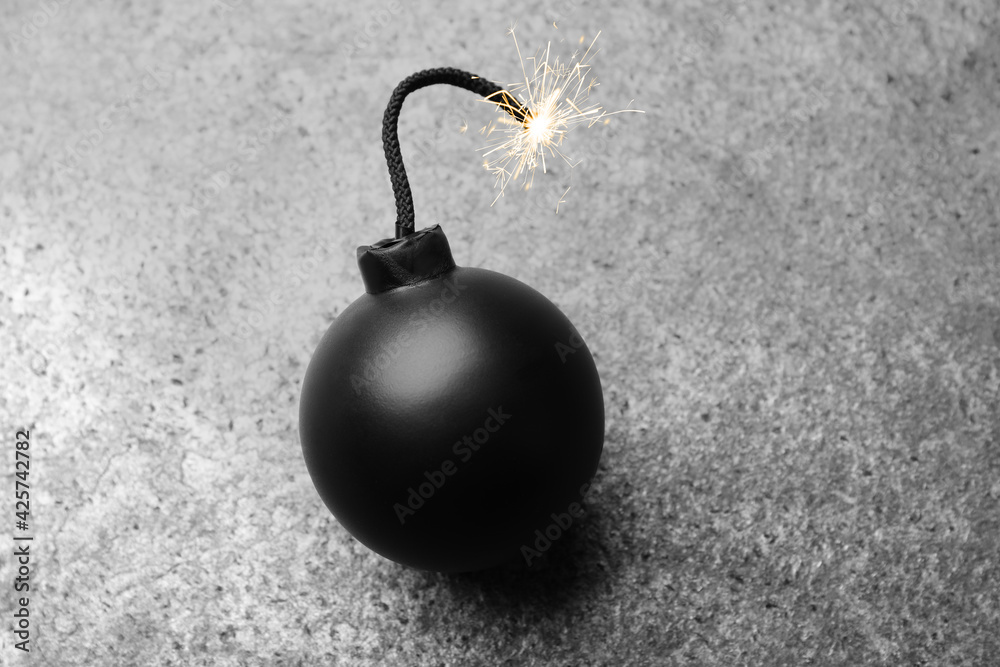 Old fashioned fuse bomb on grey table, above view Old fashioned fuse bomb on grey table, above view