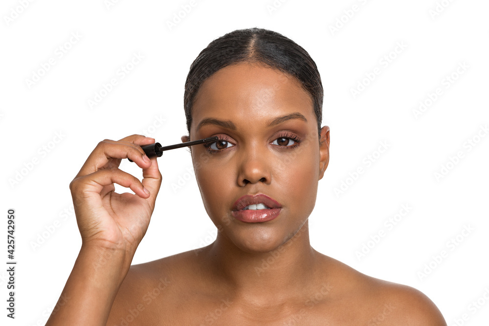 Ethnic woman applying mascara on eyelashes