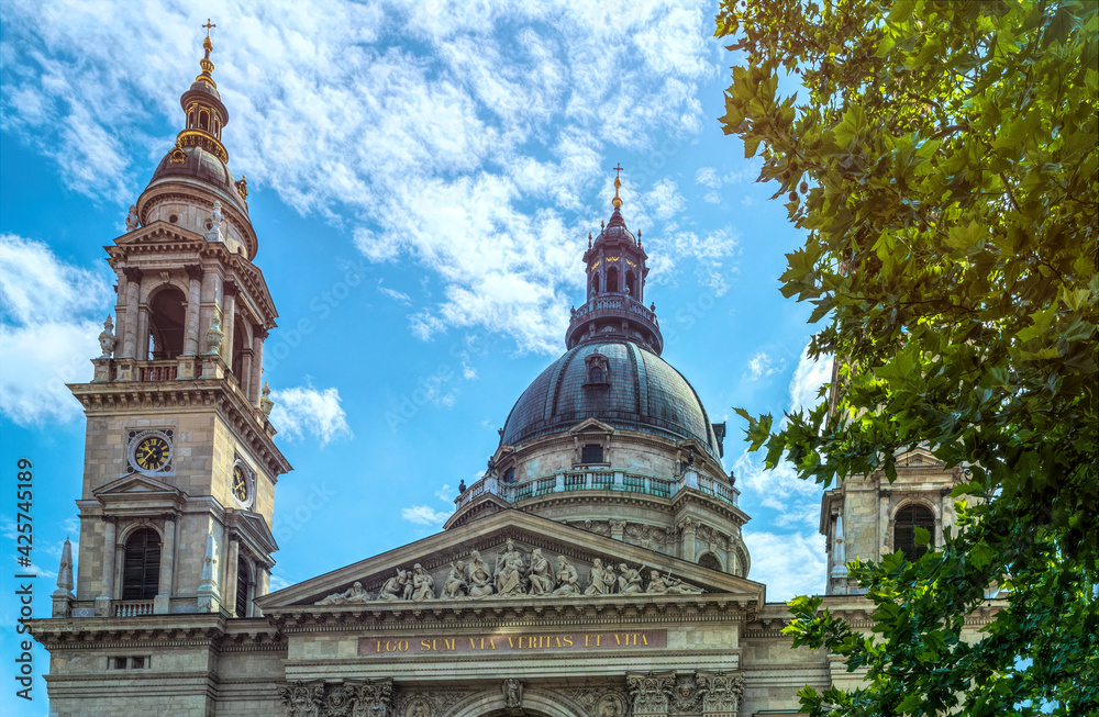 Budapest, Hungary - July 14, 2019: majestic facade of the old St. Stephen's Basilica in Budapest and crowd of tourists on the street, Hungary. Great Catholic Cathedral, built in the Baroque style