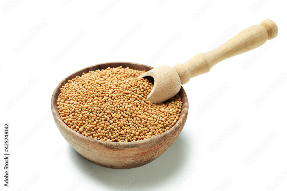 Bowl with mustard seeds and scoop isolated on white background Bowl with mustard seeds and scoop isolated on white background