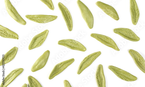 Dried durum pasta with spinach (foglie d'ulivo) in olive leaf shape pattern isolated on white background, top view