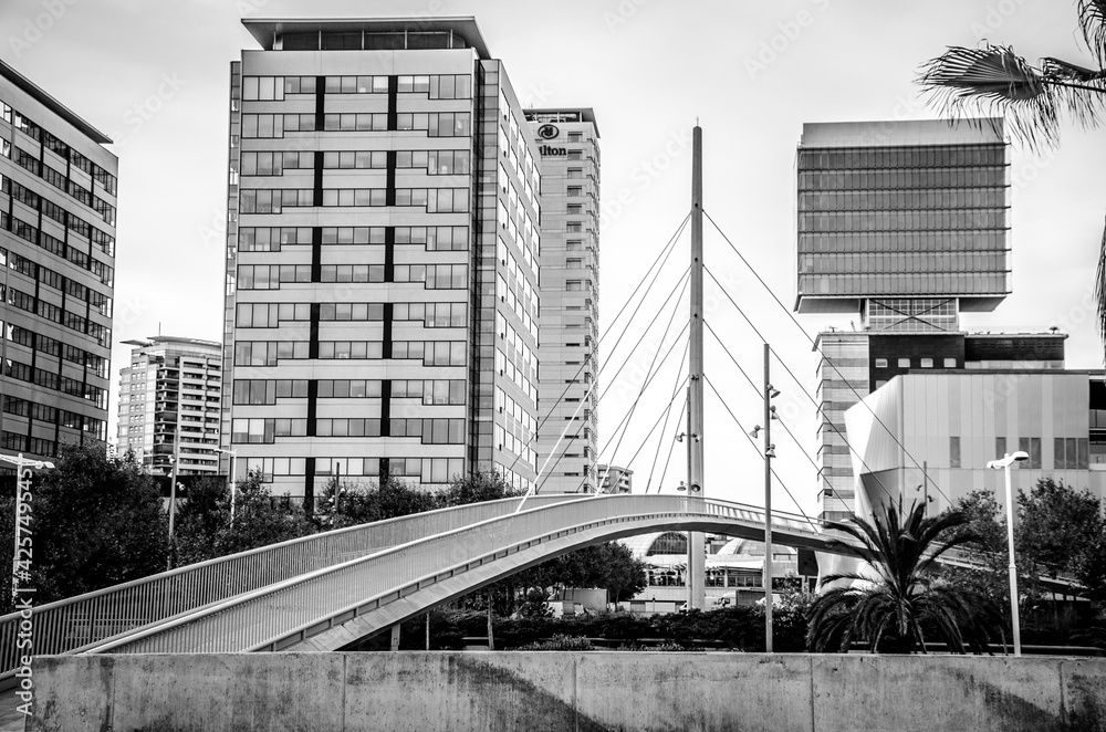 Fototapeta premium Monochrome bridge beside Barcelona's city beach with modern architecture
