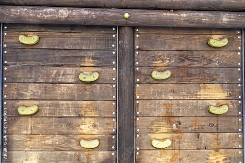 Wooden wall for climbing on a children's playground, background