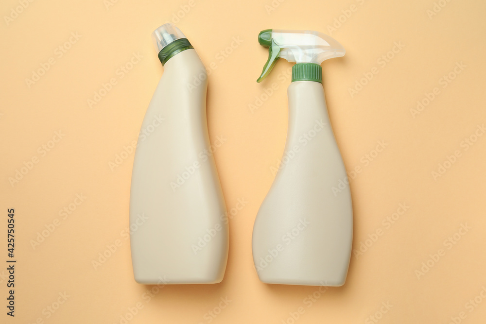 Blank detergent bottles on beige background, space for text Blank detergent bottles on beige background, space for text