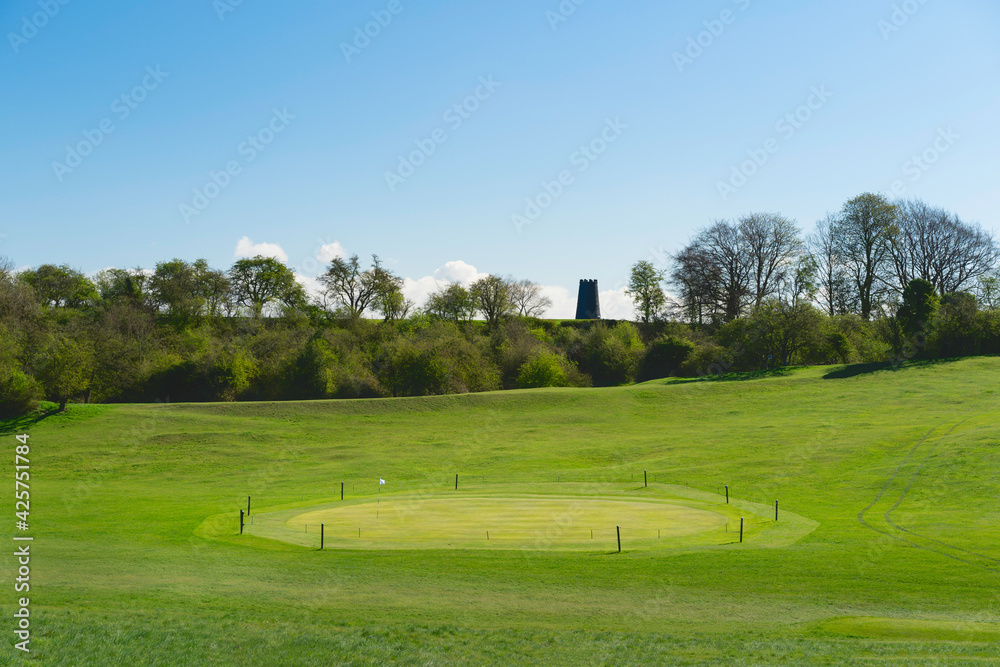 Public golf course and parkland with Black mill on horizon in spring. Beverley, UK.