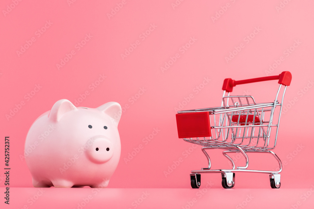 Pink piggy Bank with a shopping cart stands on a pink background. Online  business shopping concept Stock Photo | Adobe Stock