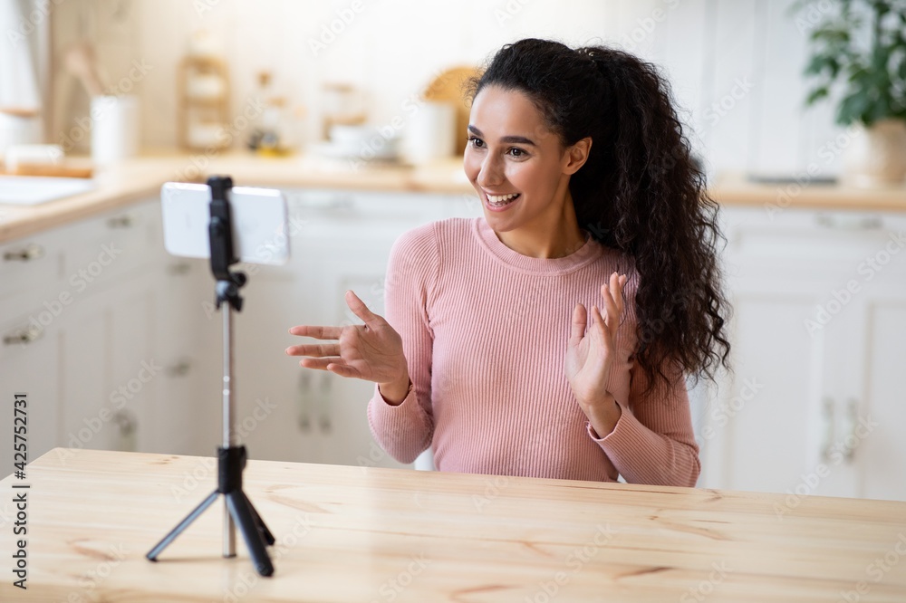 Vlogging Concept. Young Influencer Lady Using Smartphone In Kitchen, Recording Video Content