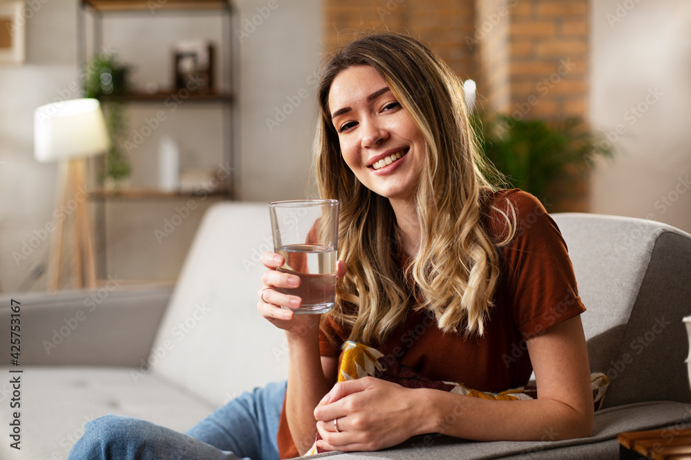 Girl holding a glass of water. Smiling girl drinking water.. Girl holding a glass of water. Smiling girl drinking water..