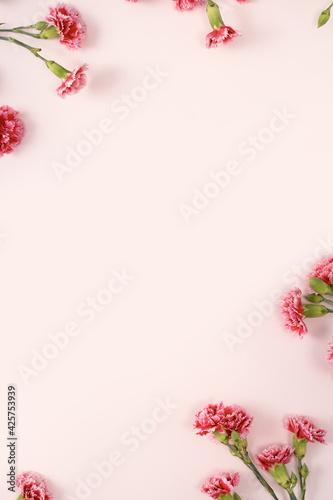 Design concept of Mother's day holiday greeting with carnation bouquet on pink table background