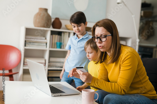 mother with kids shopping online from home