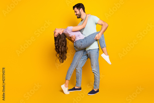 Full length body size view of attractive passionate cheerful couple dancing tango isolated over bright yellow color background