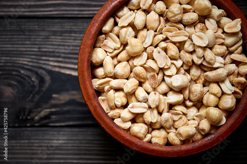 Nuts bowl on wooden background. Healthy vegan food.
