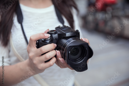 woman holding camera in street