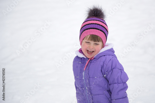 Laughing girl on a background of white snow