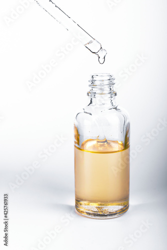 Brown glass bottles with drops Essential liquid in dropper. Selective focus. Focus on dropper.