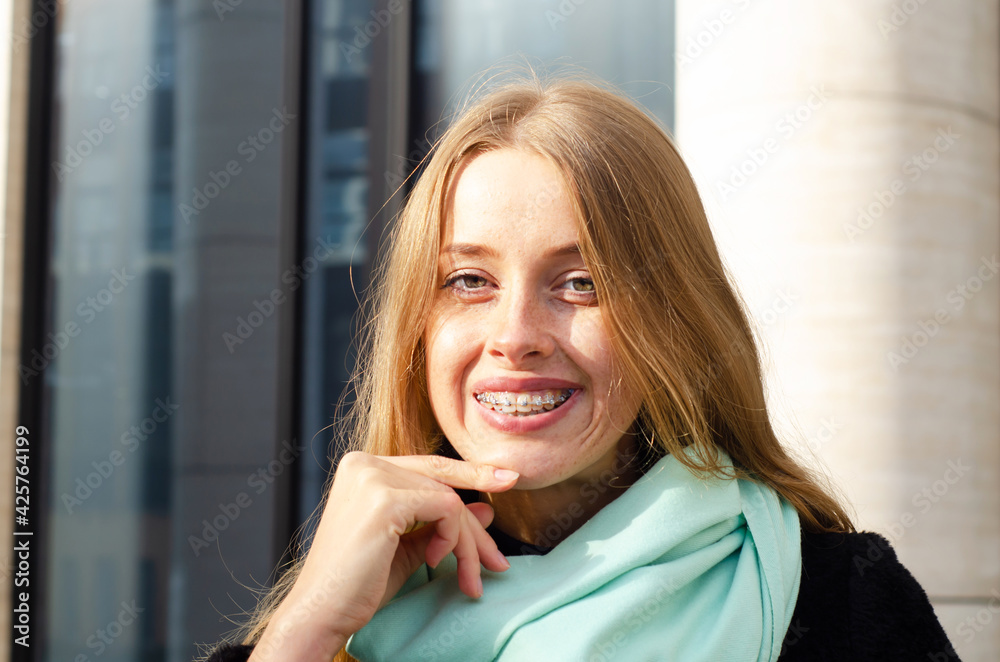 happy pretty woman with braces smiling broadly, show her smooth ...