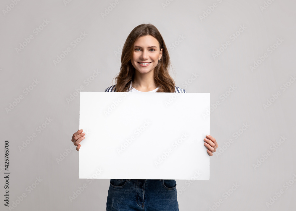 Smiling Millennial Lady Holding Blank Placard With Copy Space For Advertisement Smiling Millennial Lady Holding Blank Placard With Copy Space For Advertisement