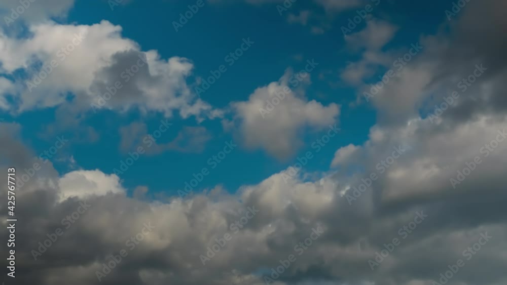 Timelapse - fast moving dramatic white clouds against blue sky. Daylight, cloudy day. Nature, freedom, time lapse concept Timelapse - fast moving dramatic white clouds against blue sky. Daylight, cloudy day. Nature, freedom, time lapse concept
