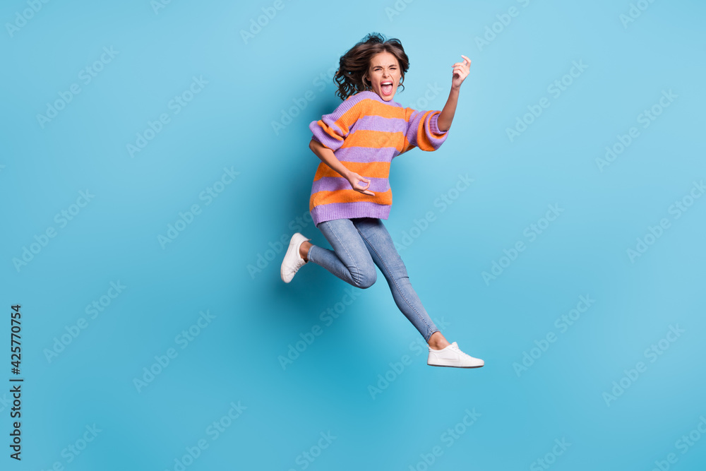 Full length body size view of charming crazy cheerful girl jumping fooling having fun isolated over bright blue color background