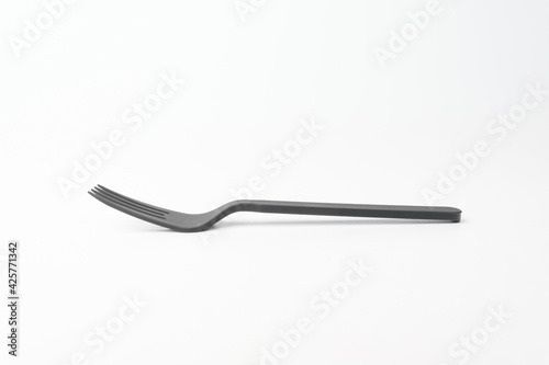 Plastic fork on white background