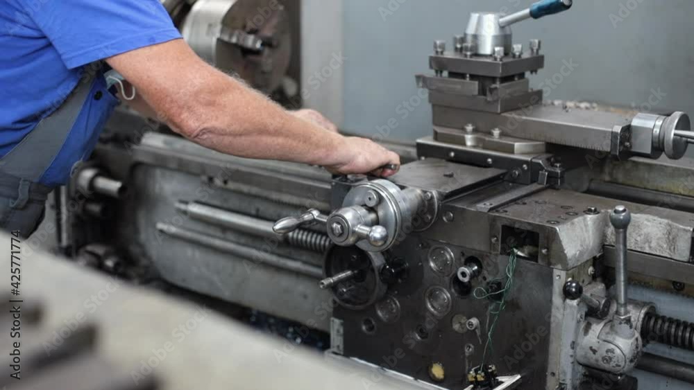 Prevention and maintenance of machine tools in the machine shop. A worker in overalls sets up a lathe to work with metal. Not a staged video. Prevention and maintenance of machine tools in the machine shop. A worker in overalls sets up a lathe to work with metal. Not a staged video.