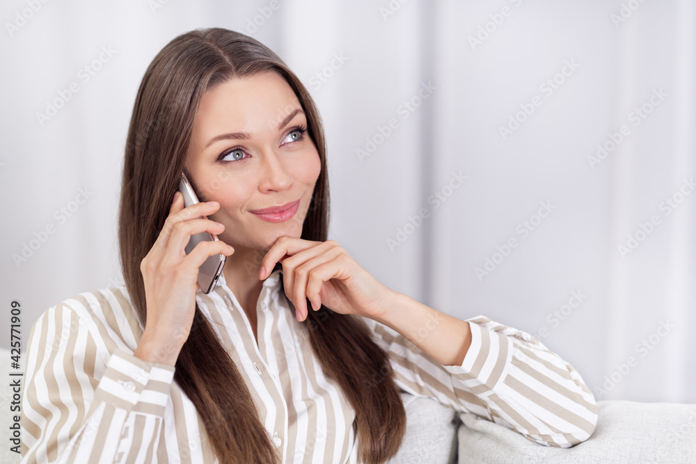Photo portrait of young business woman talking on cellphone got idea looking blank space in striped shirt Photo portrait of young business woman talking on cellphone got idea looking blank space in striped shirt