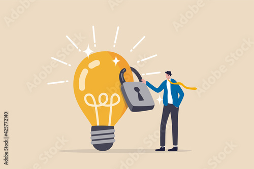Intellectual property, patented protection, copyright reserved or product trademark that cannot copy concept, businessman owner standing with light bulb idea locked with padlock for patents. photo