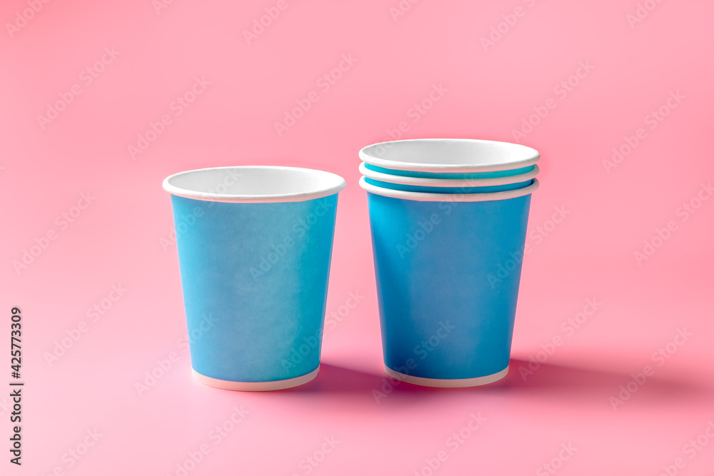 Disposable paper cup on a pink background. Disposable tableware. Disposable goods. Concept. High quality photo