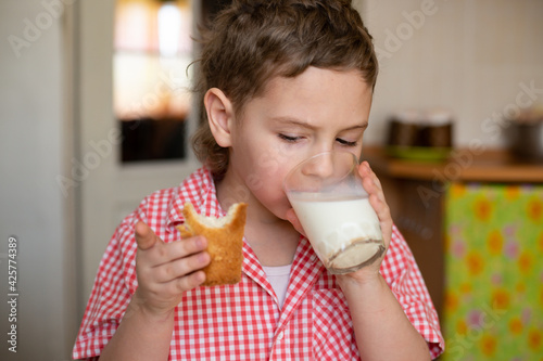 child eats Easter cake and drinks milk. homemade cakes for Easter religious holiday