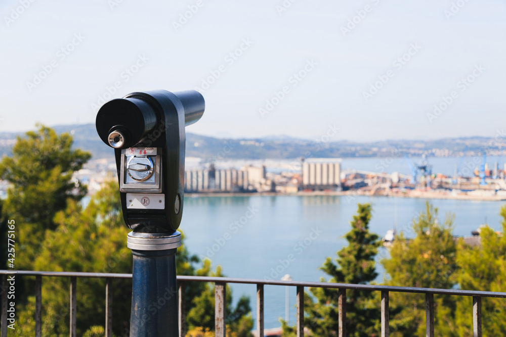 Sightseeing tourist coin operated telescope at watching point with scenic view at the port of Ancona, Italy