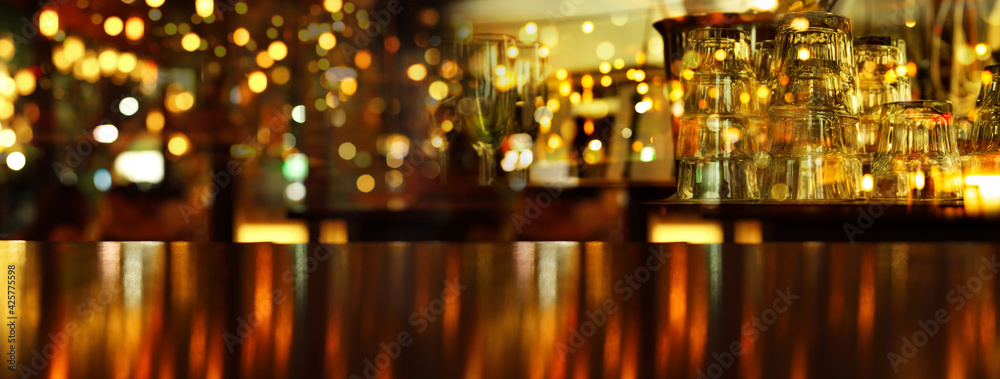 drinking glass in bar at night with orange lamp light with wood table party  banner background. Stock Photo | Adobe Stock