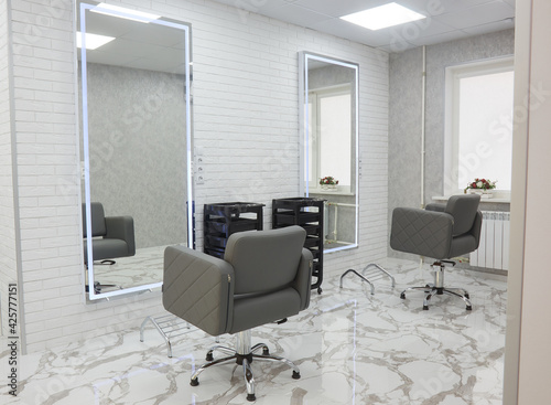 barber chair and mirrors in an elite beauty salon, cosmetologist's office interior