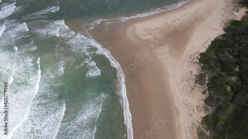 Ocean Waves Washing Up On Sandy Shore Of Sawtell Beach - Bonville Headland Lookout In Sawtell, NSW, Australia. - aerial pullback photo