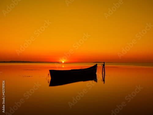 beautiful view of old fishing boat silhouette before sunrise