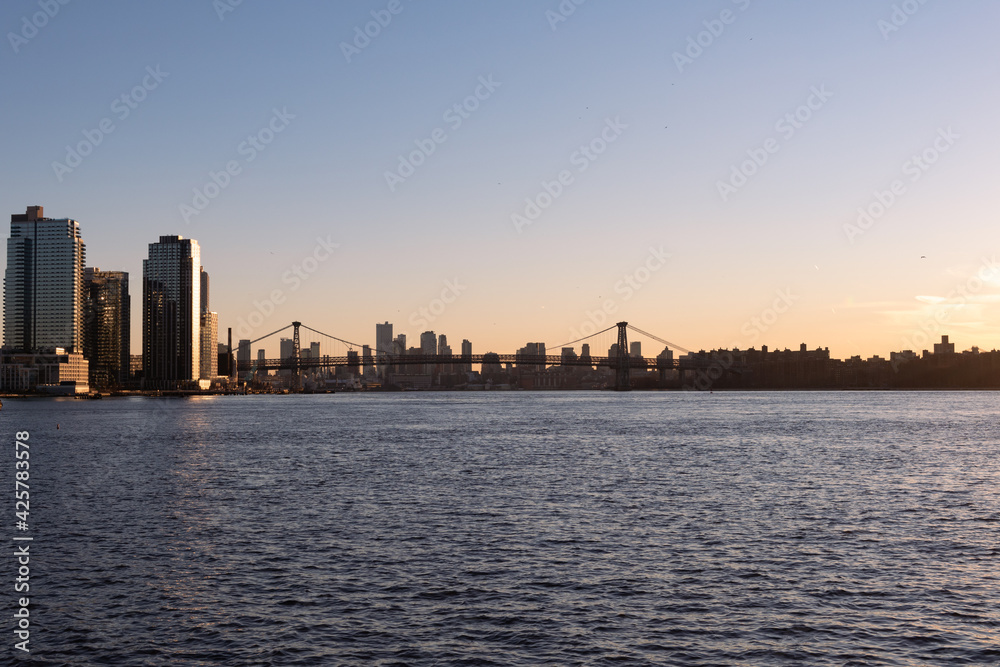 Sunset along the East River with the Williamsburg Bridge in New York City