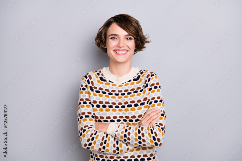 Portrait of attractive cheerful brown-haired girl folded arm wear casual pullover isolated over grey pastel color background Portrait of attractive cheerful brown-haired girl folded arm wear casual pullover isolated over grey pastel color background