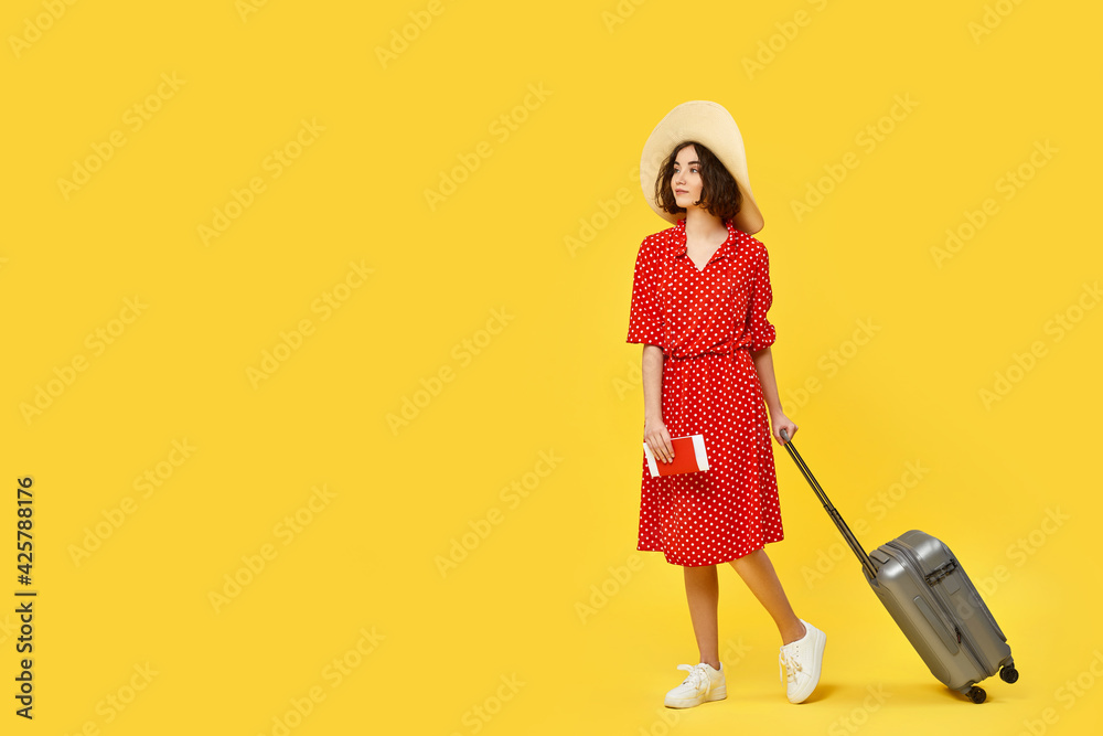 woman with suitcase going traveling on yellow background. woman with suitcase going traveling on yellow background.