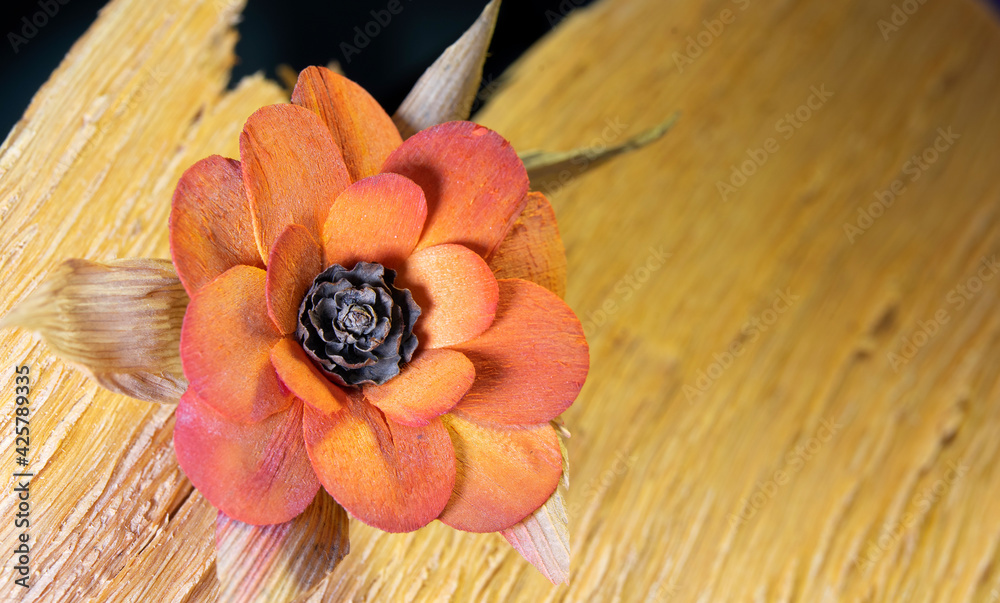 Flower made of wood and cones on a raw tree stump Flower made of wood and cones on a raw tree stump