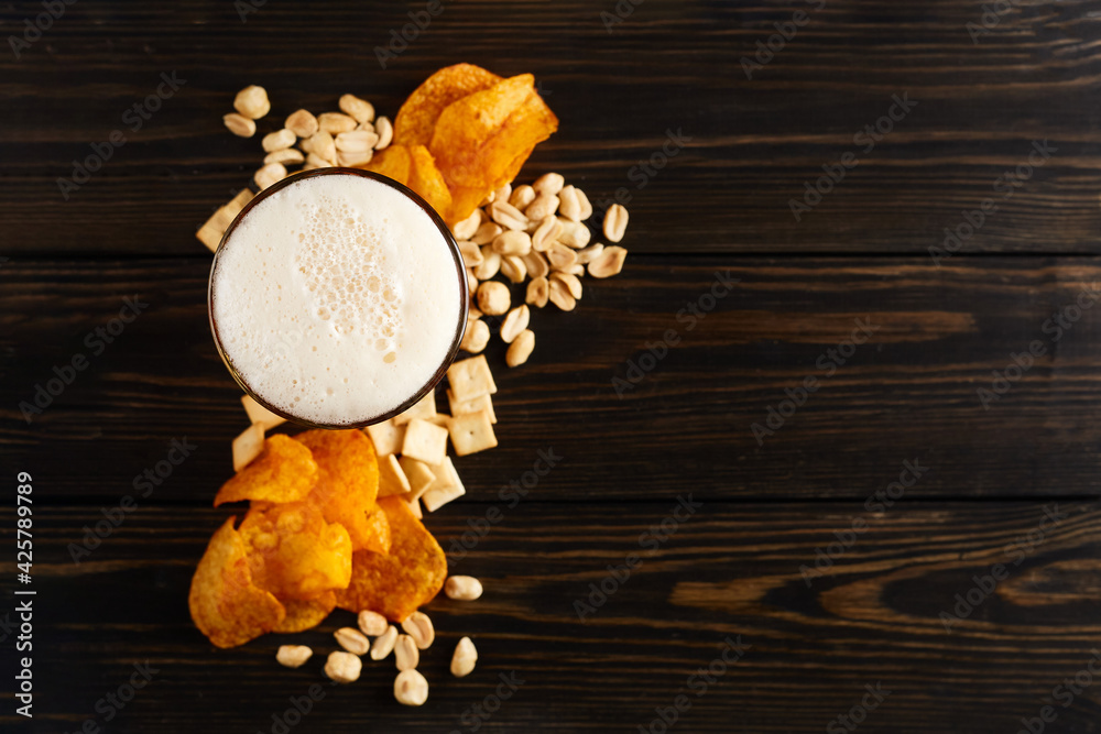 lager beer and snacks on wooden table. Nuts, chips, crackers. Craft beer. Beerboard. lager beer and snacks on wooden table. Nuts, chips, crackers. Craft beer. Beerboard.
