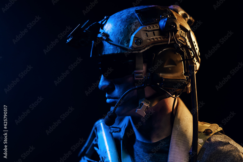 Portrait of special forces soldier in helmet and glasses in the dark Portrait of special forces soldier in helmet and glasses in the dark