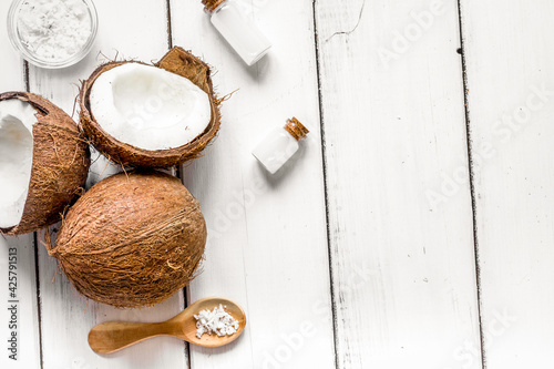 organic cosmetics concept with coconut on table background top view
