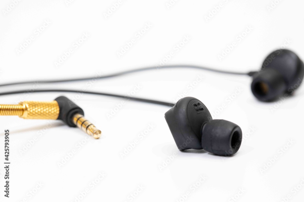 Top view in ear headphone isolate on white background , Black gold headphones. Top view in ear headphone isolate on white background , Black gold headphones.