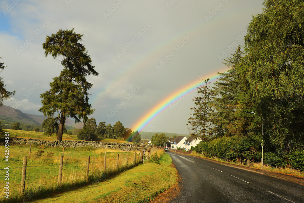 Beautiful rainbow slicing the sky after a storm in the Highlands