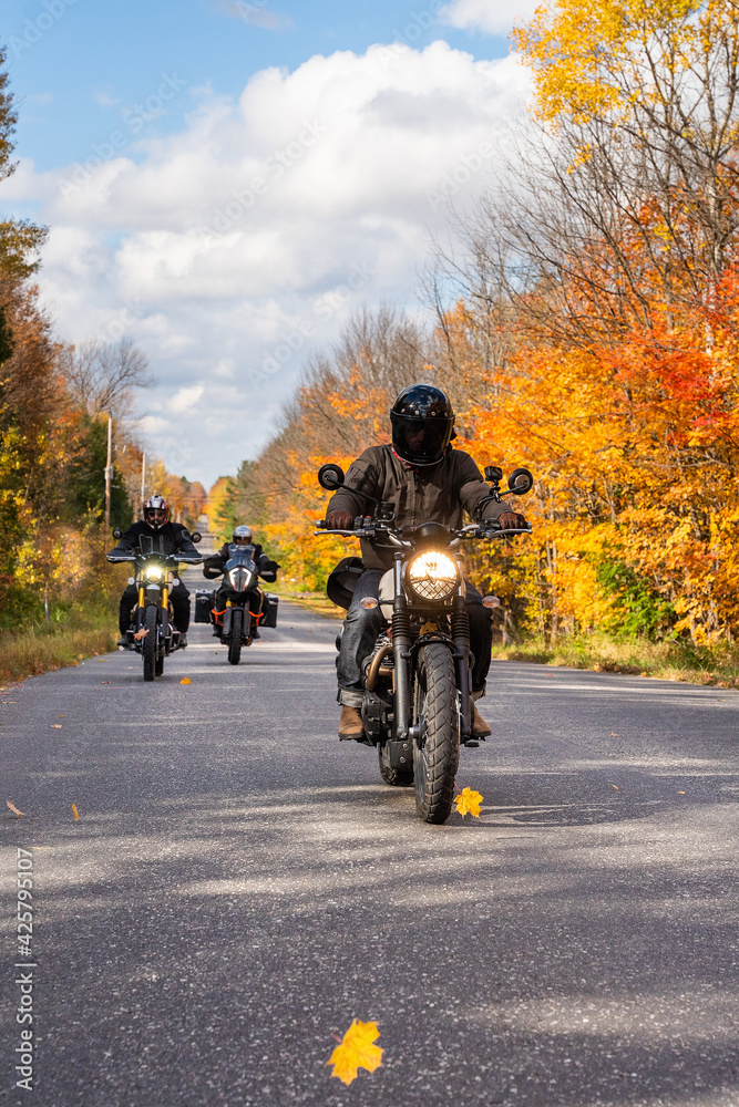 Group of friends riding motorcycles in the fall in Canada