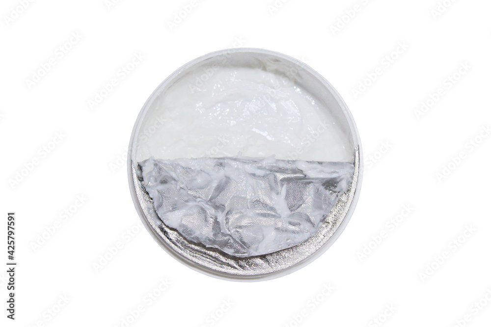 Opened plastic jar of cream. Face and body cream. Top view. Selective focus. The isolated object on a white background. Isolate. Opened plastic jar of cream. Face and body cream. Top view. Selective focus. The isolated object on a white background. Isolate.