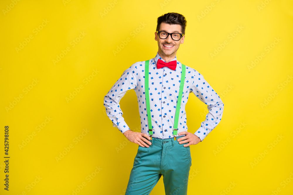 Portrait of attractive cheerful content guy wearing nice look print shirt isolated over bright yellow color background Portrait of attractive cheerful content guy wearing nice look print shirt isolated over bright yellow color background