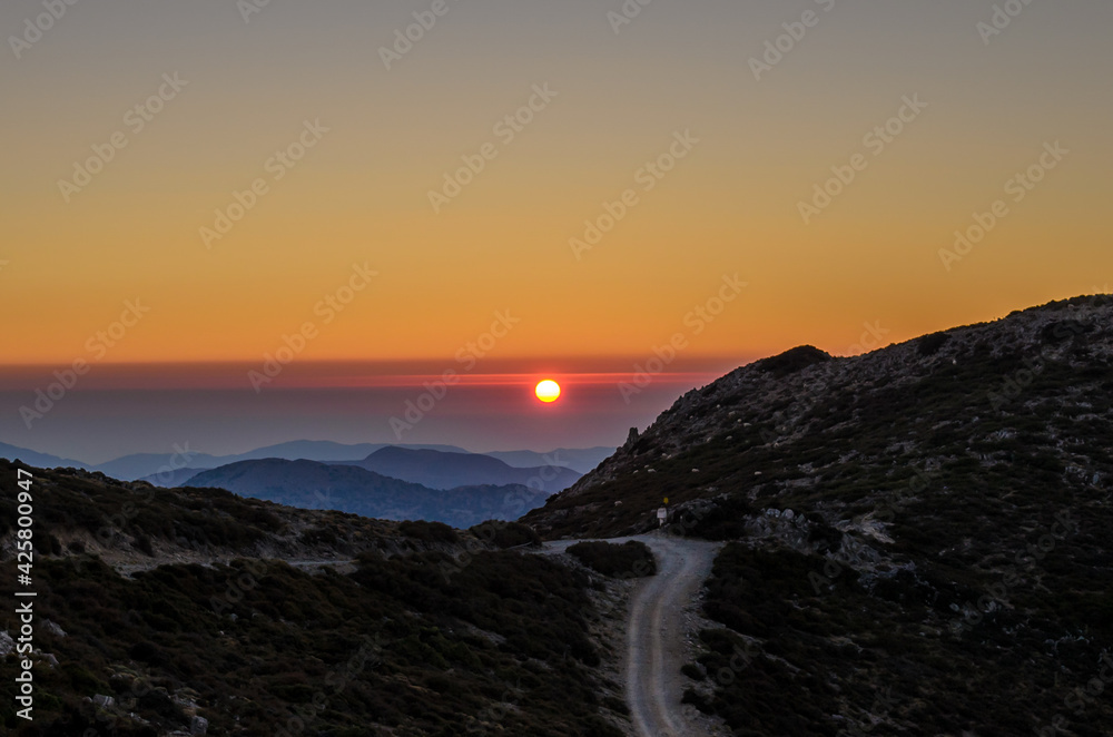 Beautiful Sunset over the Mountains of Crete Island, Greece. Panoramic View of the Horizon from the Mountain Top. Beautiful Sunset over the Mountains of Crete Island, Greece. Panoramic View of the Horizon from the Mountain Top.